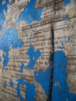 a close-up shot of some torn advertisement for a chemistry tutor; it's been torn away to reveal bright blue paint
